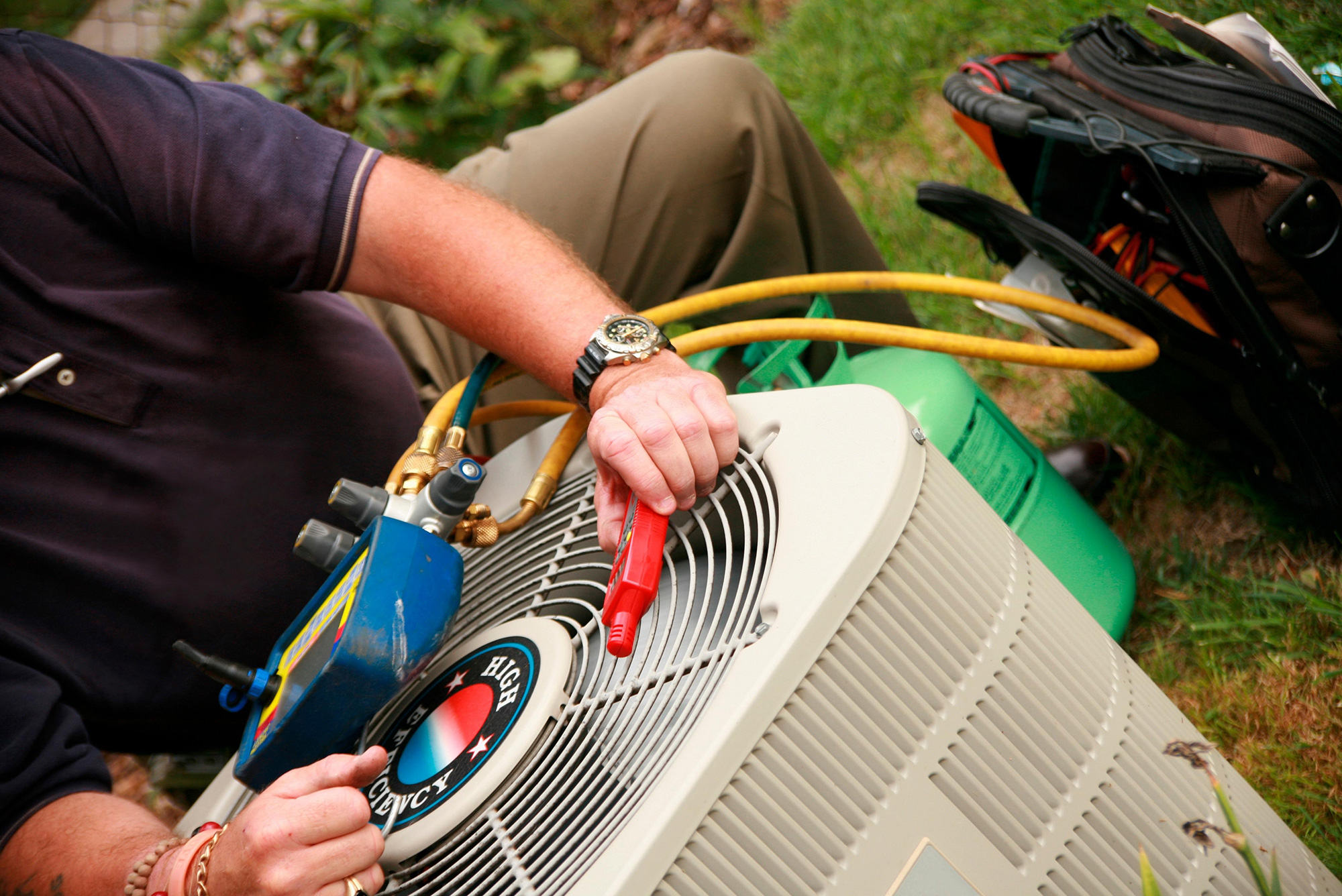 An HVAC professional works through field service management challenges while on the job